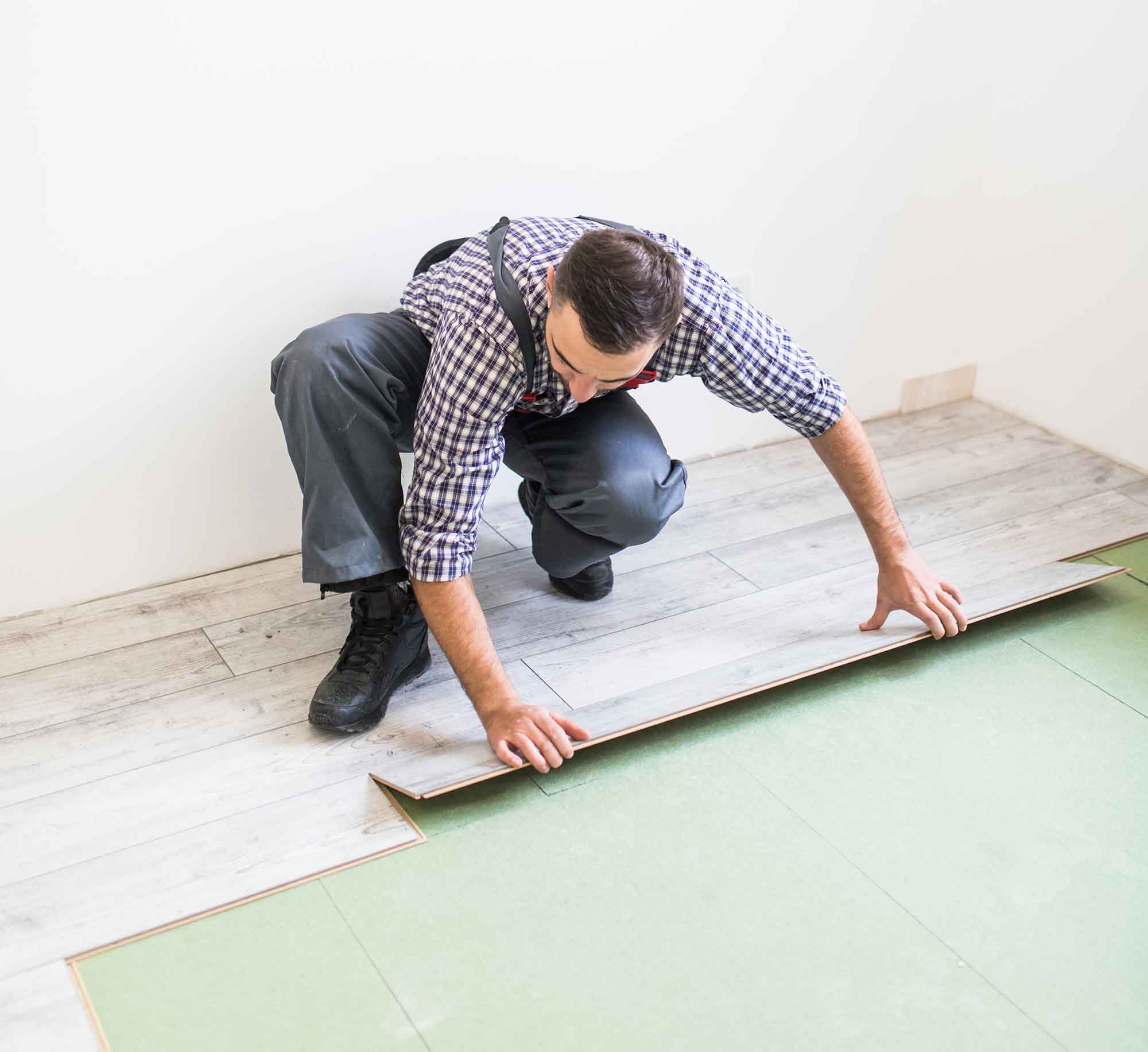 worker processing a floor with laminated flooring boards - Steam Team